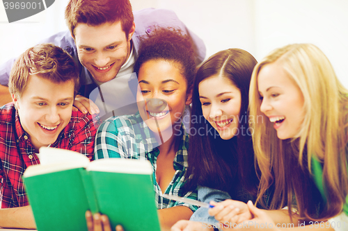 Image of students reading book at school