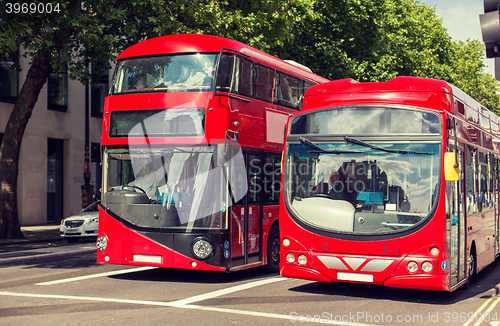 Image of city street with red double decker buses in london