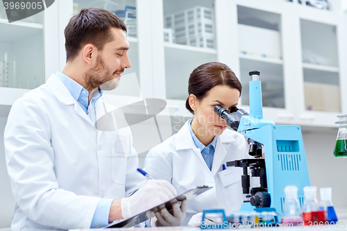 Image of young scientists making test or research in lab