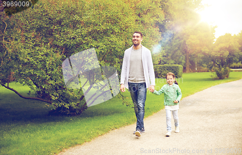 Image of happy family walking in summer park