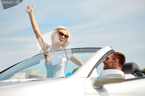 Image of happy man and woman driving in cabriolet car