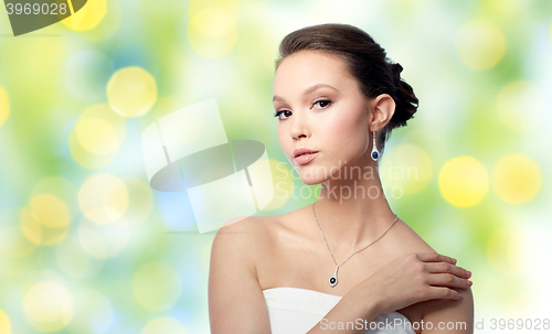 Image of beautiful asian woman with earring and pendant