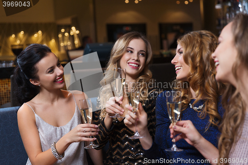 Image of happy women with champagne glasses at night club