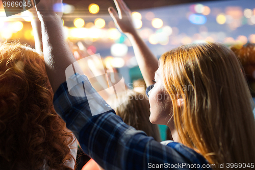 Image of close up of happy people at concert in night club