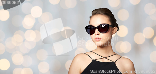 Image of beautiful young woman in elegant black sunglasses