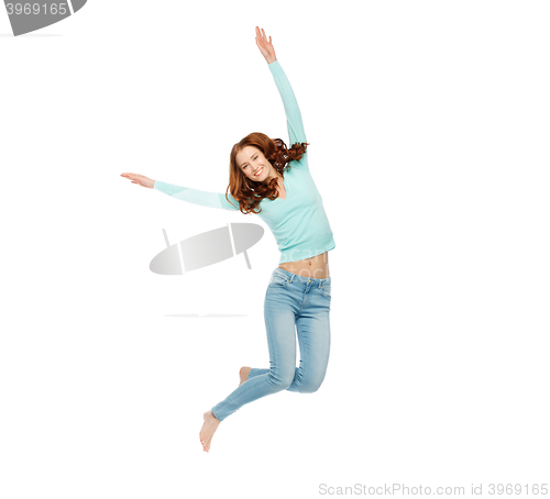 Image of smiling young woman jumping in air