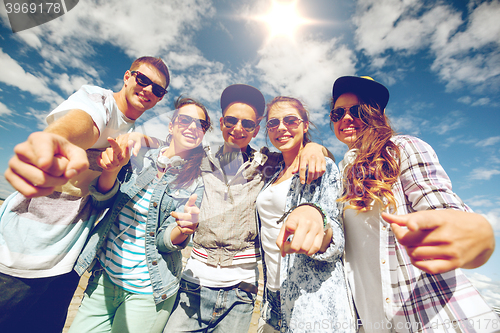 Image of smiling teenagers in sunglasses hanging outside