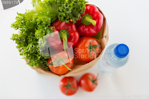 Image of basket of fresh vegetables and water at kitchen