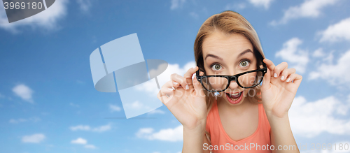 Image of happy young woman or teenage girl in eyeglasses