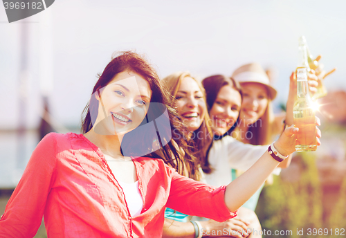 Image of girls with drinks on the beach