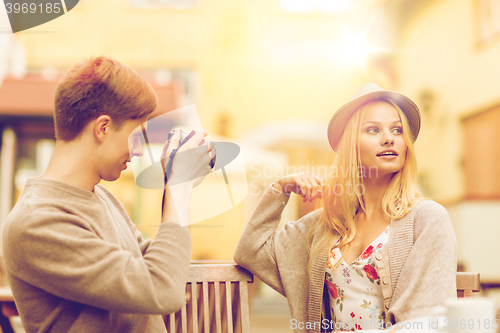 Image of couple taking photo picture in cafe