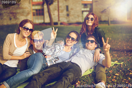 Image of group of happy students showing victory gesture