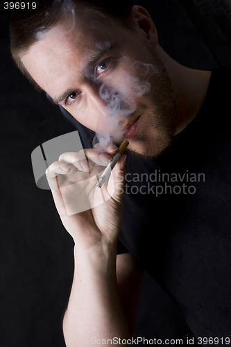 Image of man smoking a cigarette