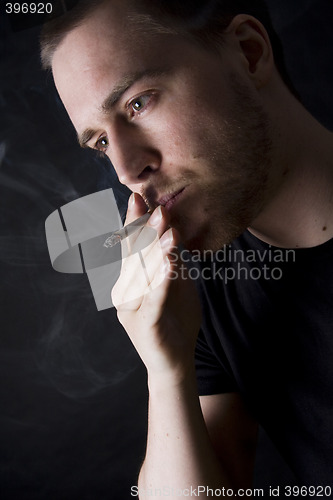 Image of man smoking a cigarette