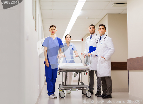 Image of group of doctors with gurney at hospital