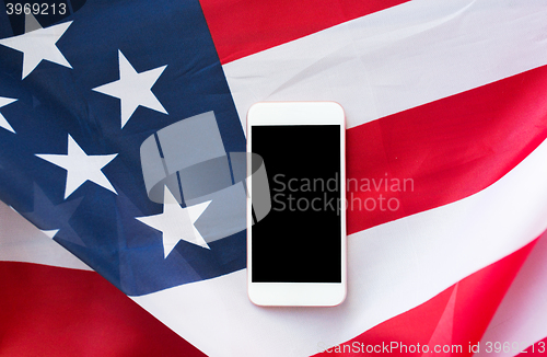 Image of close up of smartphone on american flag