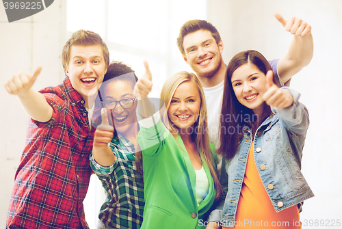 Image of students showing thumbs up at school