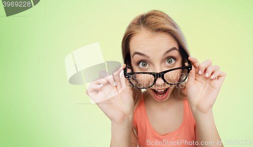 Image of happy young woman or teenage girl in eyeglasses