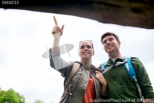 Image of smiling couple with backpacks hiking