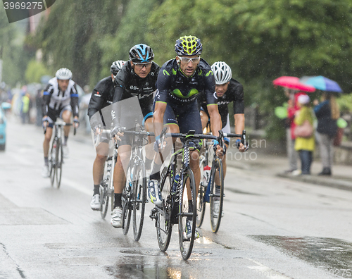 Image of Group of Cyclists Riding in the Rain - Tour de France 2014