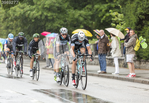 Image of Group of Cyclists Riding in the Rain - Tour de France 2014