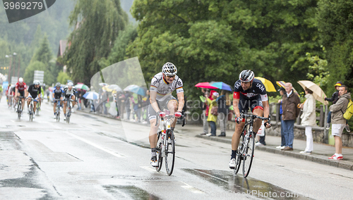 Image of Two Cyclists Riding in the Rain - Tour de France 2014