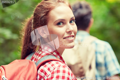 Image of group of smiling friends with backpacks hiking