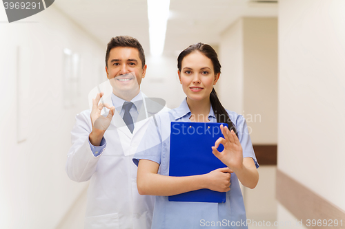 Image of doctor and nurse showing ok sign at hospital