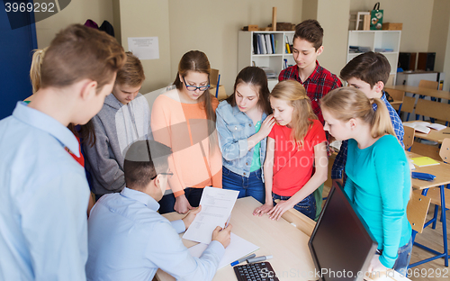 Image of group of students and teacher with tests at school