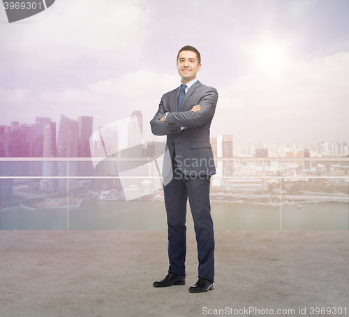 Image of happy smiling businessman over singapore city 