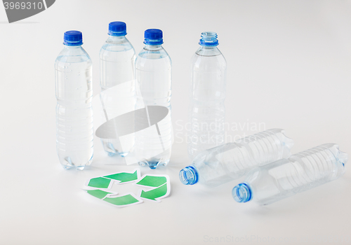 Image of close up of plastic bottles and recycling symbol