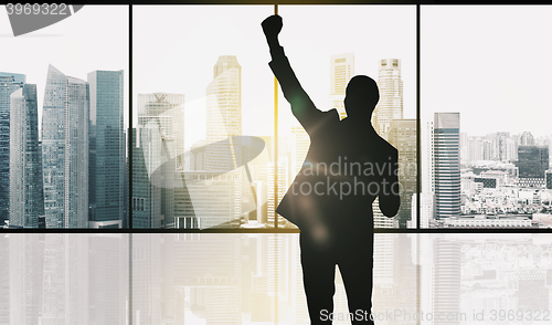 Image of silhouette of business man over office background