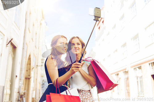 Image of women shopping and taking selfie by smartphone