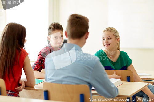 Image of group of students with notebooks at school lesson