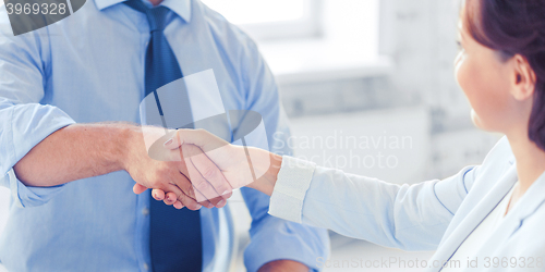 Image of business people shaking hands in office