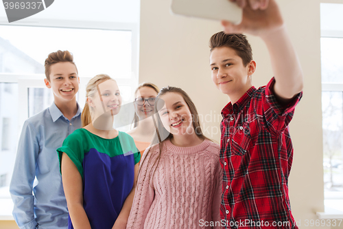 Image of group of students taking selfie with smartphone