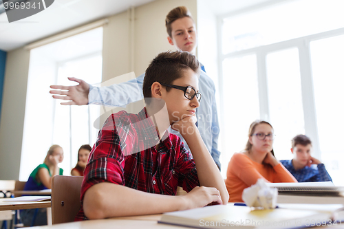 Image of classmate offending student boy at school