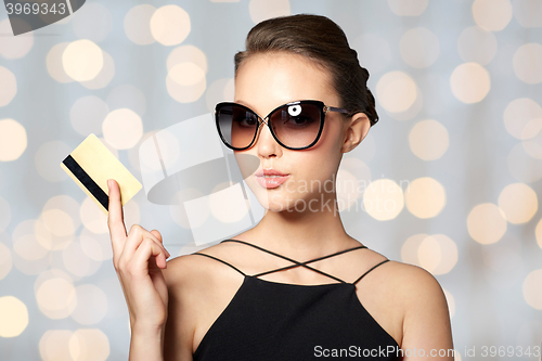 Image of beautiful young woman in elegant black sunglasses