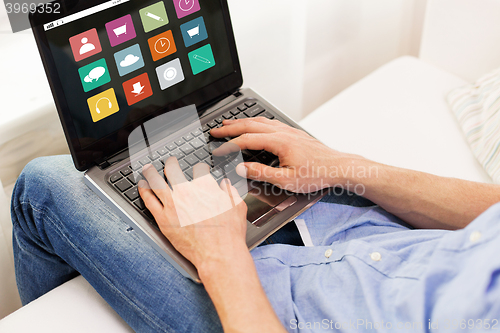 Image of close up of man typing on laptop computer at home