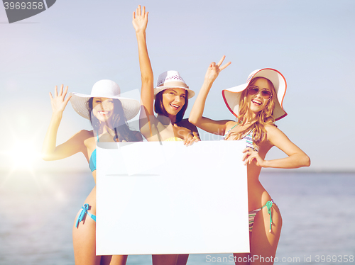 Image of girls with blank board on the beach