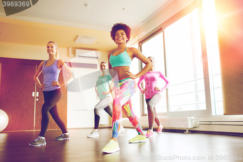 Image of group of happy women working out in gym