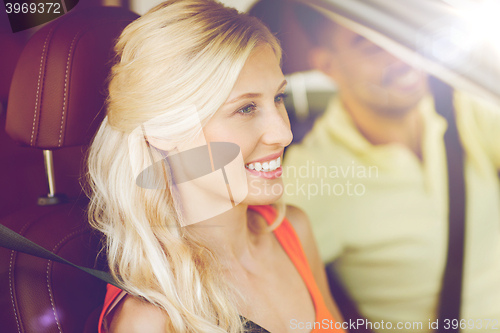 Image of happy man and woman driving car