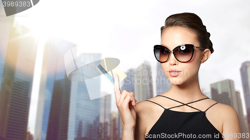 Image of beautiful young woman in elegant black sunglasses