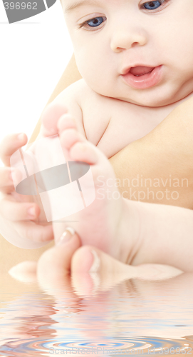 Image of bathing baby in mother hands