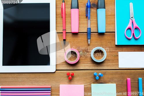 Image of close up of school supplies and tablet pc