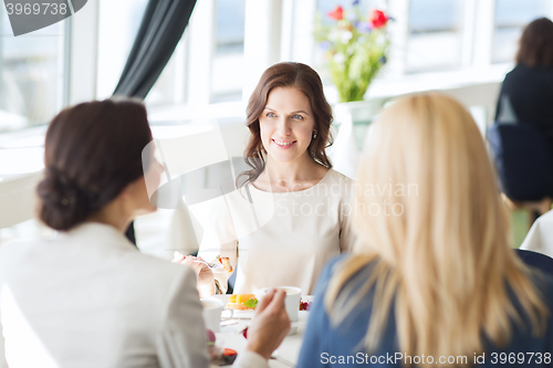 Image of women eating dessert and talking at restaurant
