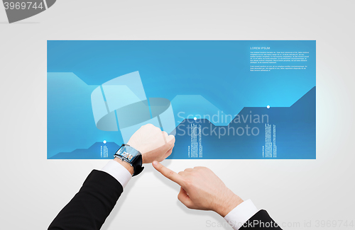 Image of businessman pointing to smart watch at his hand