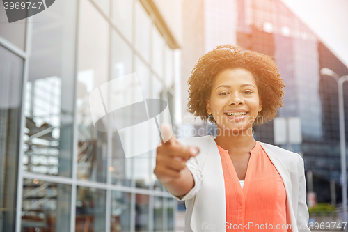 Image of happy young african american businesswoman in city