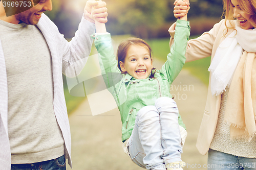 Image of happy family walking in summer park and having fun