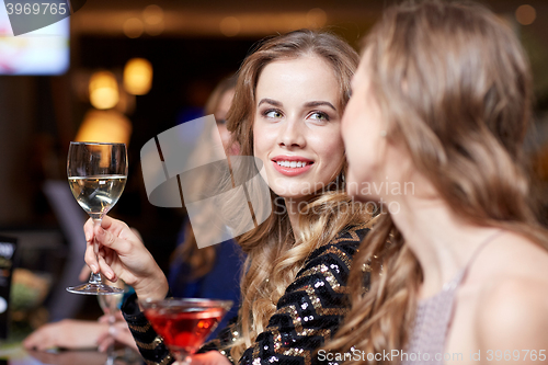 Image of happy women with drinks at night club